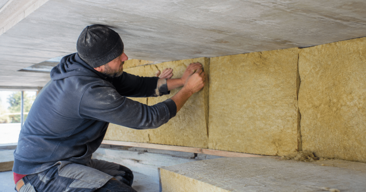 Ouvrier pose isolant sous dalle beton renovation